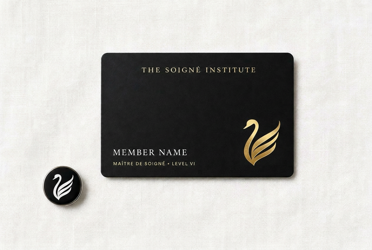 The Maître de Soigné black membership card and white enamel swan pin